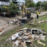 Crews and householders clear flood damage in St Lucia.