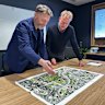Prior + Partners director of master planning Jonathan Rose and Arcadis Brisbane Games and legacy lead Paul Allan at the firm’s Brisbane office, looking over a map of the Victoria Park site.