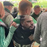 A young Celtic supporters draped himself in an Ange Postecoglou flag on Saturday.