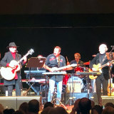US session guitarist Louis Shelton (centre) - who played the opening guitar riff on Last Train to Clarksville - playing with Micky Dolenz (left) and Mike Nesmith (right) at QPAC on Wednesday night.