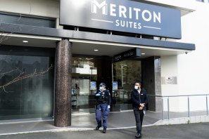 Police and security at the front door of the Meriton Apartments in Waterloo on Tuesday.