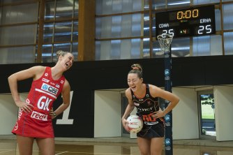 NSW Swifts’ Teigan O’Shannassy and Giants Netball’s Lauren Moore share a laugh before the Sydney derby on Sunday.