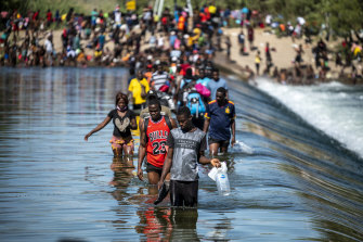 Migrants cross between Texas and Mexico at the Rio Grande in Ciudad Acuna.
