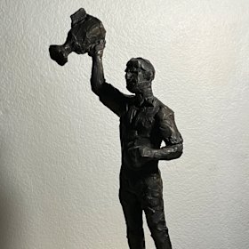 Cathy Weiszmann’s sculpture of Paul Roos with the 2005 AFL premiership trophy.