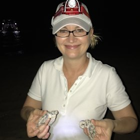 Anna Marsden, managing director of Great Barrier Reef Foundation with green turtle hatchlings.