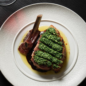Pork chop with herb salsa, broccoli and prune sauce.