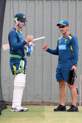 Handscomb talks with national coach Justin Langer in the nets.