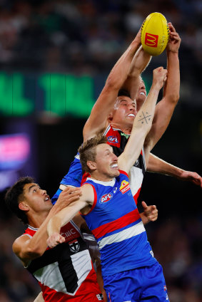 St Kilda’s Mitch Owens outreaches  Bulldogs Bailey Dale (front) and Tim English while teammate Rowan Marshall 9bottom left) also competes for the ball.