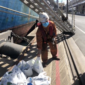 Chen Chen from China retrieves Neville Manson’s 23 comfort packages from the foot of the gangplank in Portland.  