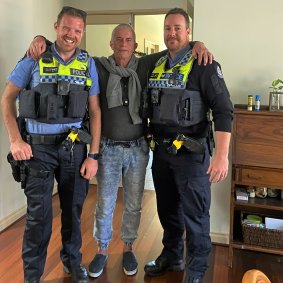 Richard Hoogewerf with police officers after he was found using the Safe & Found database.