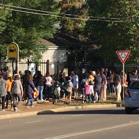 Dozens of parents wait for students outside Kent Road Public School on Wednesday afternoon.