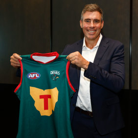 Tasmanian football great Matthew Richardson poses with the Devils’ first AFL jumper.