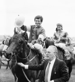  Co-owner, Dennis Gowing, leads Melbourne Cup winner, What a Nuisance with jockey Pat Hyland. 