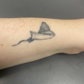 The small eagle ray tattoo on the side of Emily’s wrist.