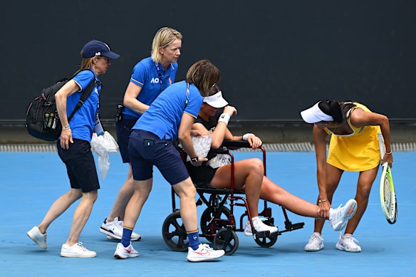 Priscilla Hon helps her opponent from the court.