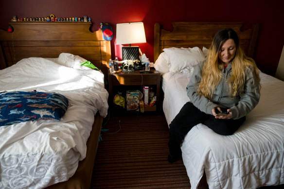 Ashley McCollum in the room that she, her son and partner share with their two dogs at a Best Western hotel.
