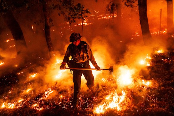 A firefighter battles the Pickett Fire burning in the Aetna Springs area of Napa County, California.