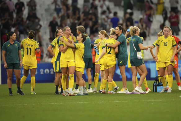 The Matildas console each other on the pitch after their 2-1 loss to the USA.