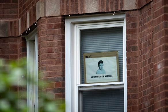 A sign calling for justice for Wadea hangs in the window of an apartment reported to be Rodriguez’s