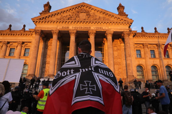 Protesters are seen outside the Reichstag with a flag of the German Reich of 1871-1918 during protests against coronavirus-related restrictions.