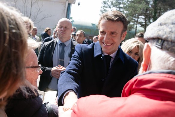 French President Emmanuel Macron greets members of the public after voting in Le Touquet.