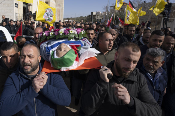 Mourners carry the body of Palestinian-American Omar Assad, during his funeral in the West Bank village of Jiljiliya, north of Ramallah. 