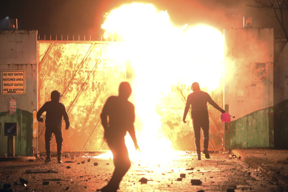 Nationalists and Loyalists clash with one another at the peace wall on Lanark Way in West Belfast, Northern Ireland, on Wednesday.