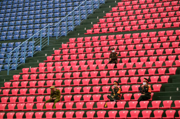 Police officers wearing masks sit in the stands as the Matildas played Vietnam in a match that was closed to the public. 