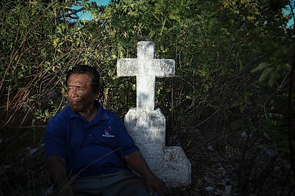 Swinley Freddy at the grave of his wife Rose, who died in 1986. She was the first to be buried on Mejatto after the people moved from Rongelap.