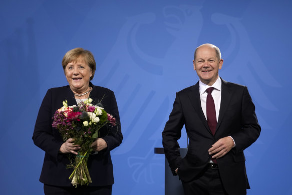 German Chancellor Olaf Scholz, right, and former Chancellor Angela Merkel.