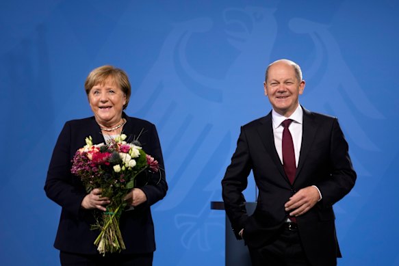 German Chancellor Olaf Scholz, right, and former Chancellor Angela Merkel.