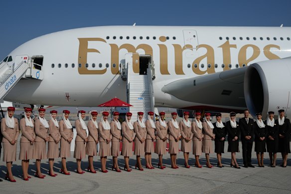 Emirates Airlines crew members pose in front of an Airbus A380-800 at the Dubai Air Show last November. 