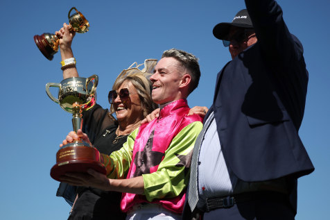 Jockey Robbie Dolan with trainers Sheila Laxon and John Symons celebrate the win.
