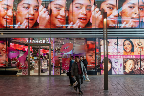 People walk past the flagship Beijing store of French beauty products retailer Sephora.