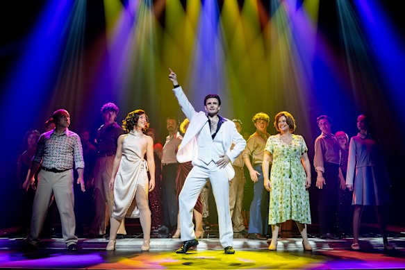 Ethan Churchill (centre) strikes an iconic pose as Tony Manero with the cast of Saturday Night Fever.