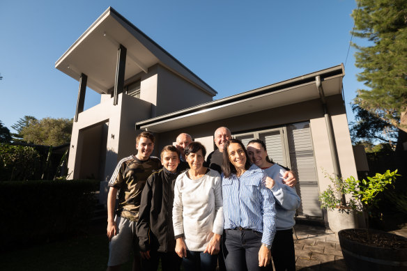 Rebecca Bissett, in striped shirt, with her family at her parents’ home in Hunters Hill.