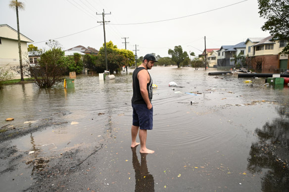 James Brady inspects flooding in his street. 