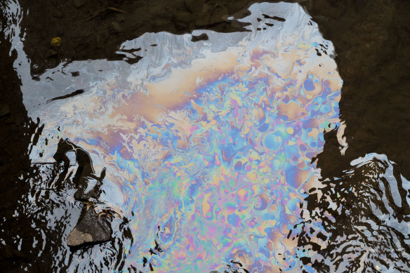 A chemical sheen on the surface of Sulphur Run downstream from the derailment site in East Palestine, Ohio .