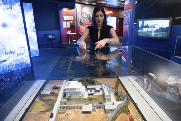 Deputy Director for the Museum in the Central Intelligence Agency Janelle Neises with a model of the compound where US forces located and killed Osama bin Laden in Abbottabad, Pakistan.