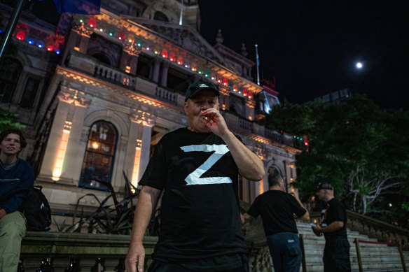 One of the Russian supporters smokes a cigarette outside Town Hall before the choir performance.