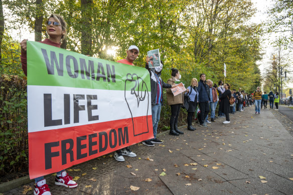 Participants in a solidarity demonstration with protesters in Iran hold a banner reading “Woman Life Freedom” in Berlin, Germany.