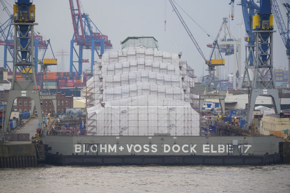 The luxury yacht “Dilbar” lies completely covered in the Blohm+Voss dock Elbe 17 in Hamburg, Germany,