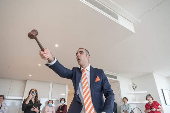 Auctioneer Michael Garofolo from Cooley Auctions prepares to sell the home.