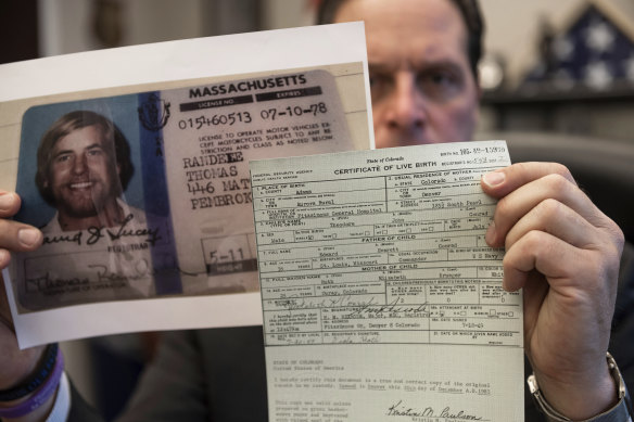 US Marshal Pete Elliott holds the birth certificate and driver’s licence of Ted Conrad at court in Cleveland this month.