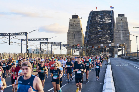 Sydney Marathon entrants run across the Harbour Bridge.