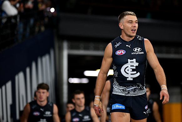 Patrick Cripps of the Blues leads his team out onto the field.