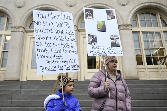 Nine-year-old Lyric Jones and mother Teran Christian outside the courthouse. Christian’s grandfather Michael Holland was a victim.