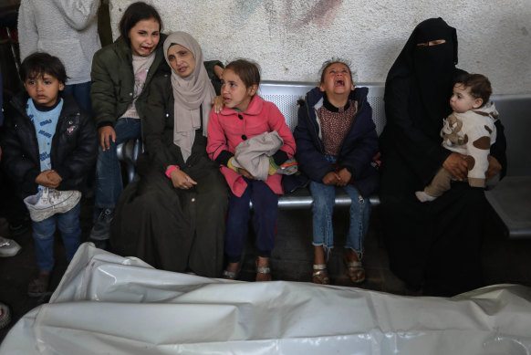 Mourners receive the bodies of victims of an Israeli strike on March 2 in Rafah, Gaza. 