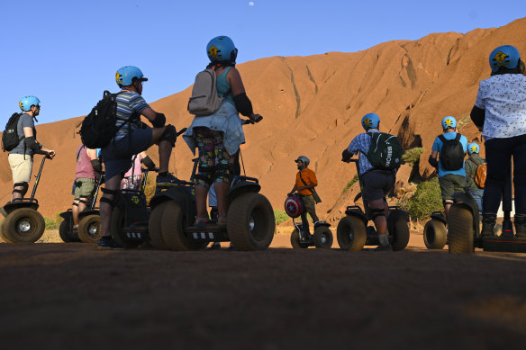 Tourists on segways at the bottom of the rock on October 10.