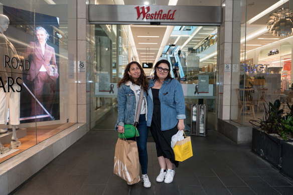 Lee-at Jacobson and Lara Abelsohn wear black ribbons after signing the condolence book inside Westfield Bondi Junction.